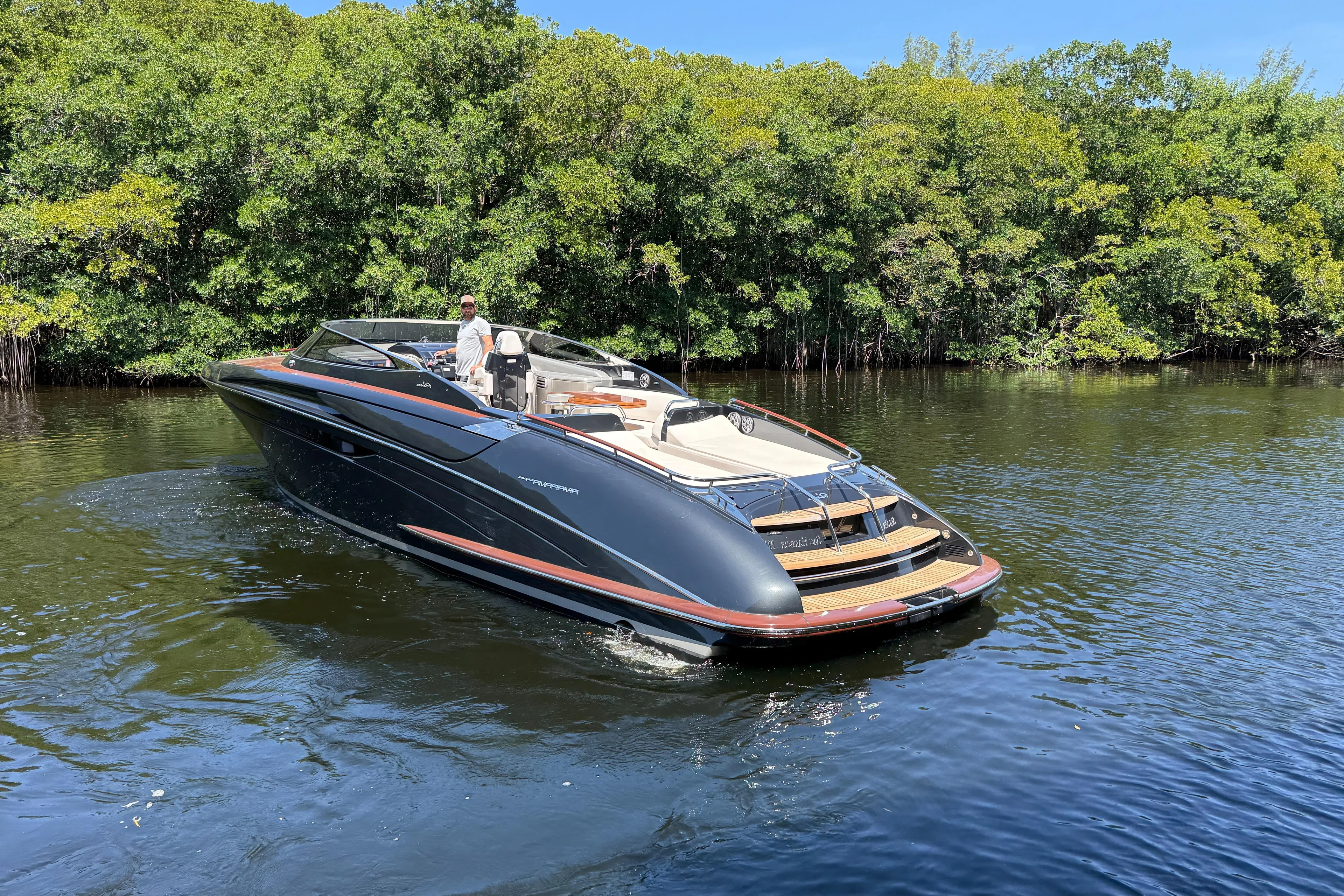 Sea Sea Yacht Photos Pics 2013 Riva Rivarama Super yacht cruising on a serene waterway with lush greenery.