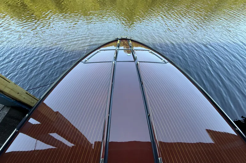 Sea Sea Yacht Photos Pics 2013 Riva Rivarama Super boat with sleek wooden deck on calm water.