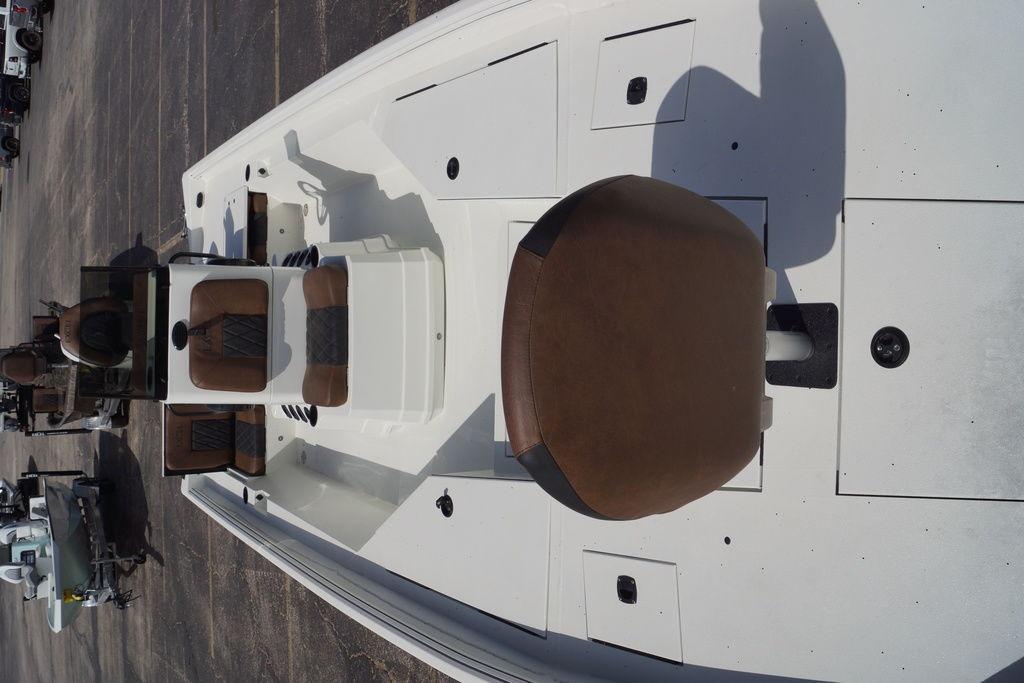 2026 Excel 230 Bay Pro Elite boat interior with brown seating and storage compartments.