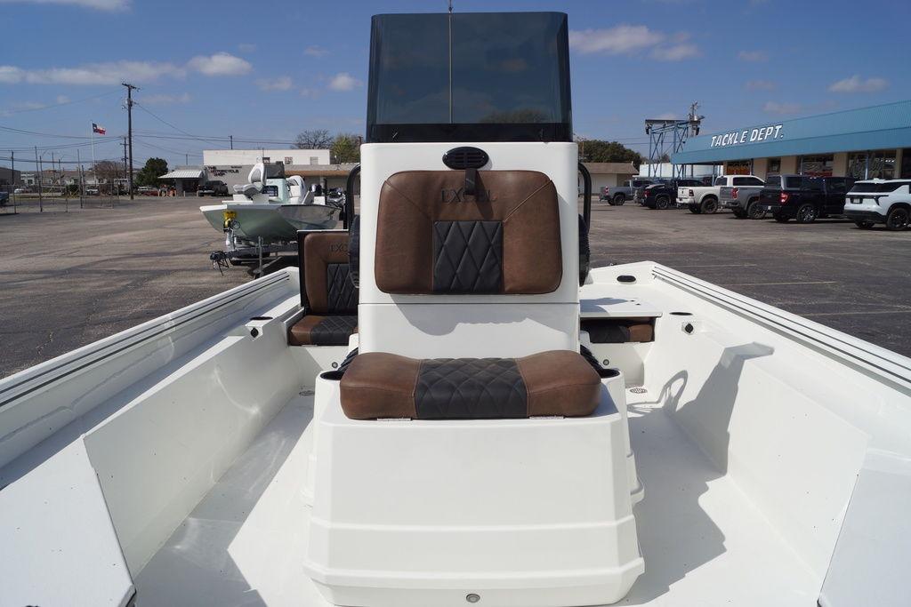 2026 Excel 230 Bay Pro Elite boat with brown seating, parked outdoors.