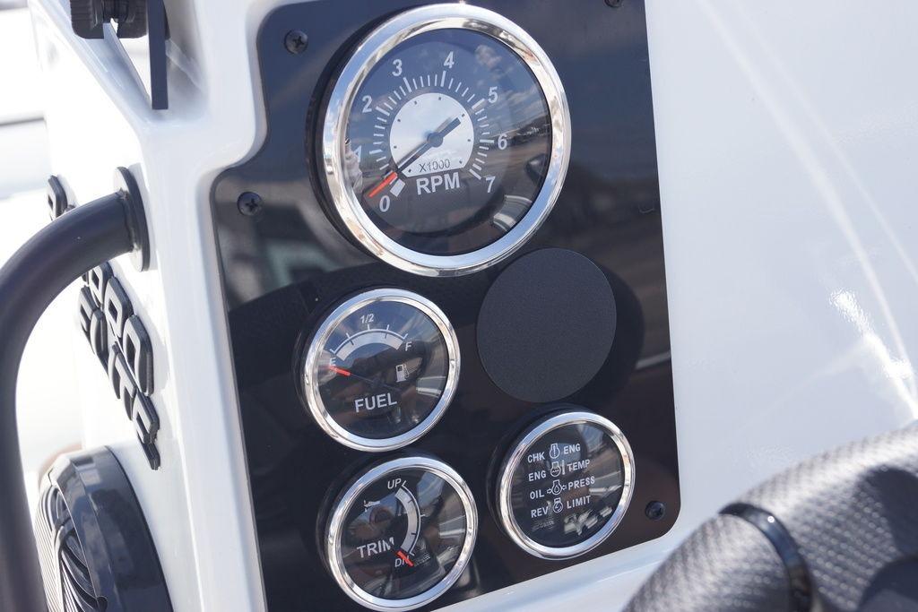 Dashboard of 2026 Excel 230 Bay Pro Elite boat with RPM, fuel, and trim gauges.