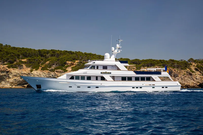 Monaco Yacht Photos Pics Luxury 1982 Feadship Classic yacht cruising near scenic coastline.