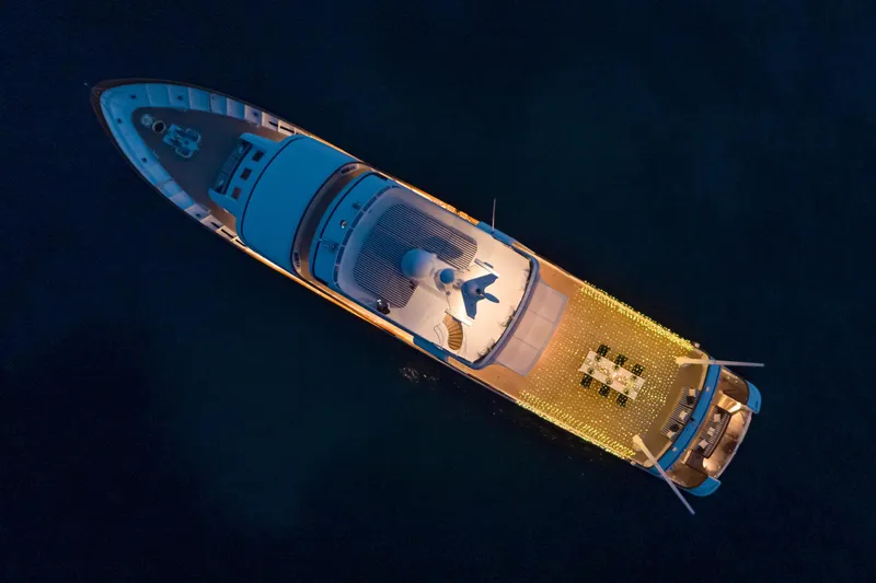 Monaco Yacht Photos Pics Aerial view of illuminated 1982 Feadship Classic yacht at night.