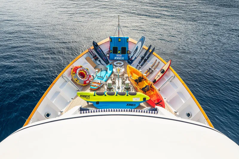 Monaco Yacht Photos Pics Bow of 1982 Feadship Classic yacht with water sports equipment and clear ocean view.