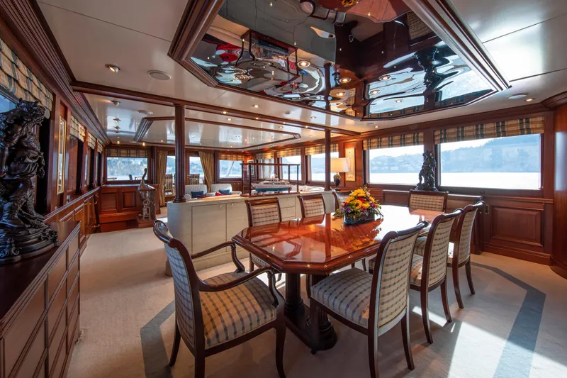 Monaco Yacht Photos Pics Luxurious interior of 1982 Feadship Classic yacht with elegant dining area and panoramic windows.