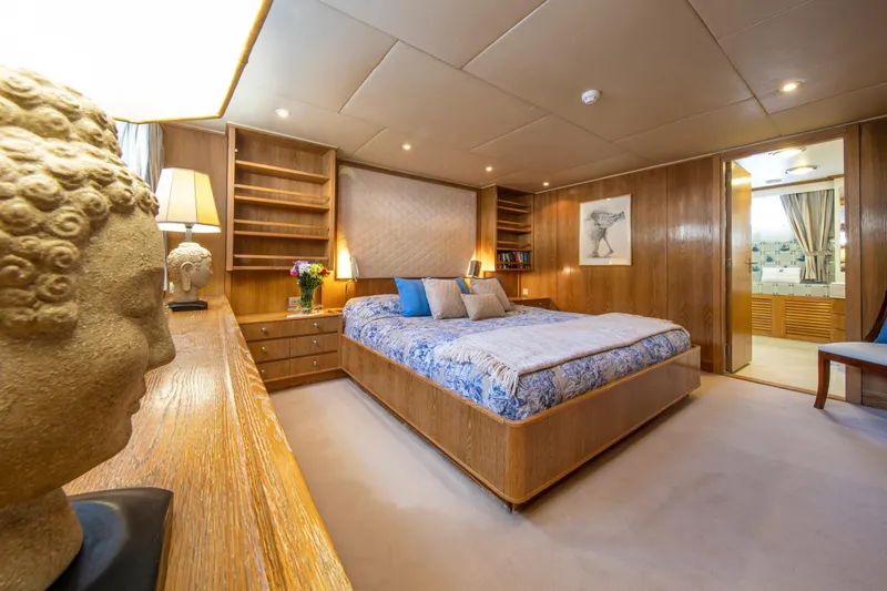 Monaco Yacht Photos Pics Luxurious 1982 Feadship Classic yacht bedroom with elegant decor and wooden furnishings.