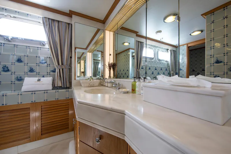 Monaco Yacht Photos Pics Luxurious 1982 Feadship Classic yacht bathroom with nautical-themed tiles and elegant fixtures.