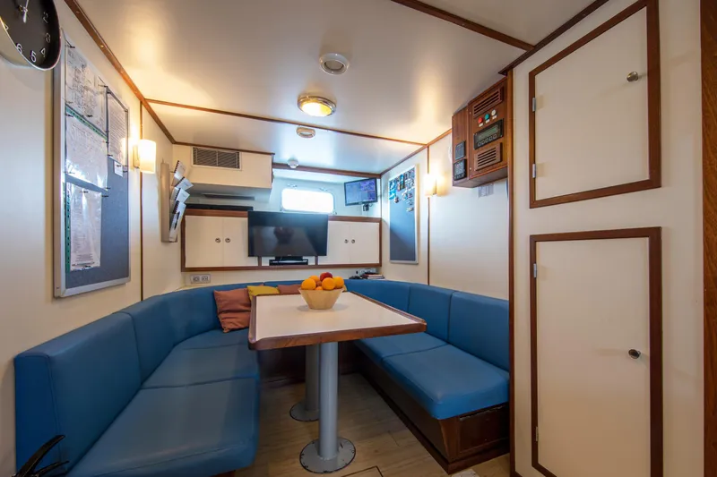 Monaco Yacht Photos Pics Interior of 1982 Feadship Classic yacht with blue seating and modern amenities.