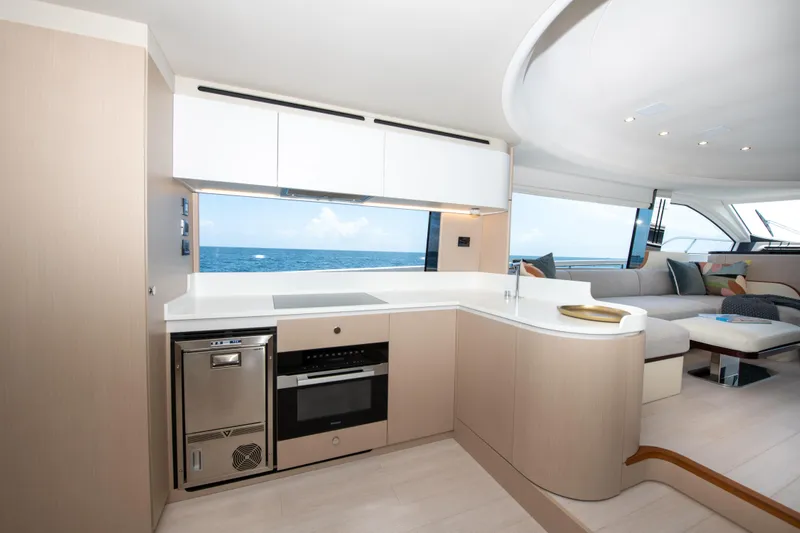 Crimson Yacht Photos Pics Luxurious interior of 2023 Azimut Fly 68 yacht with modern kitchen and ocean view.