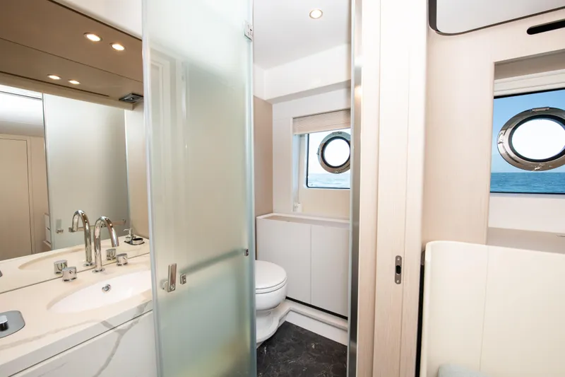 Crimson Yacht Photos Pics Luxurious bathroom on 2023 Azimut Fly 68 yacht with modern fixtures and ocean view.