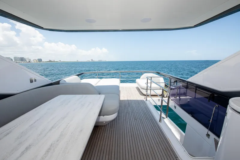 Crimson Yacht Photos Pics Luxurious 2023 Azimut Fly 68 yacht deck with ocean view and elegant seating.