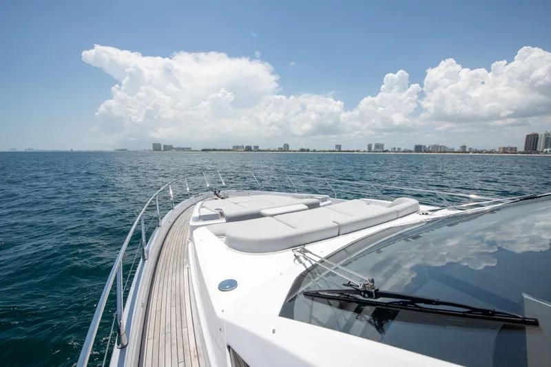 Crimson Yacht Photos Pics 2023 Azimut Fly 68 yacht cruising on open sea under clear skies.