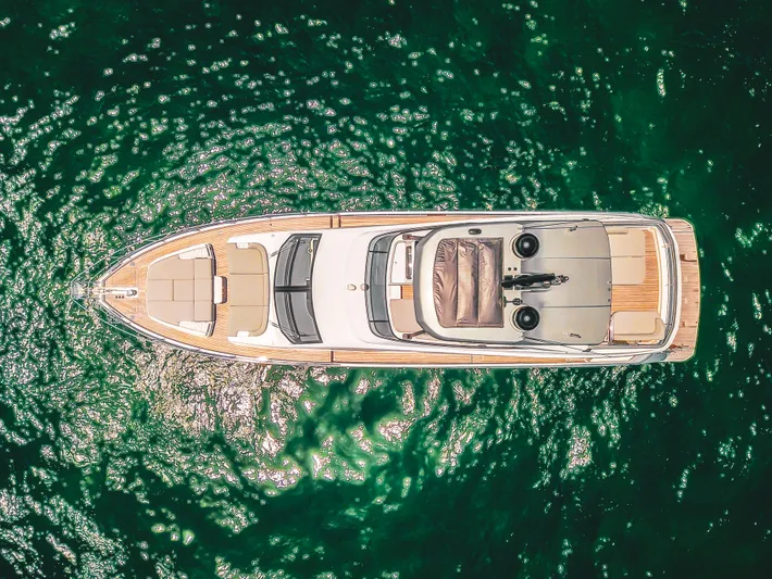 Crimson Yacht Photos Pics Aerial view of 2023 Azimut Fly 68 yacht on sparkling green water.