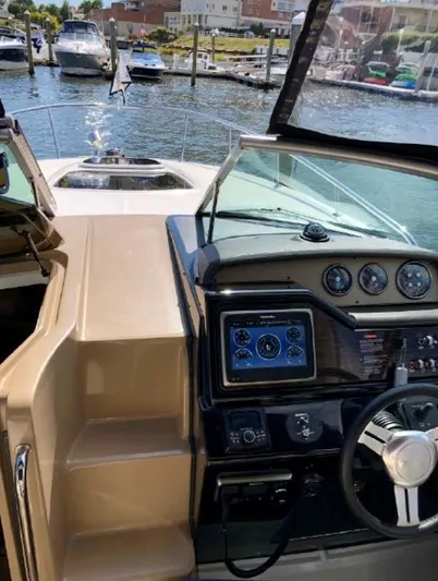  Yacht Photos Pics 2017 Sea Ray Sundancer 280 helm with modern controls, docked in a marina.