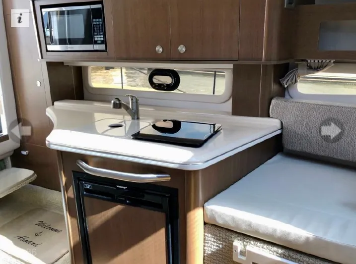  Yacht Photos Pics Interior of 2017 Sea Ray Sundancer 280 with kitchenette and seating area.