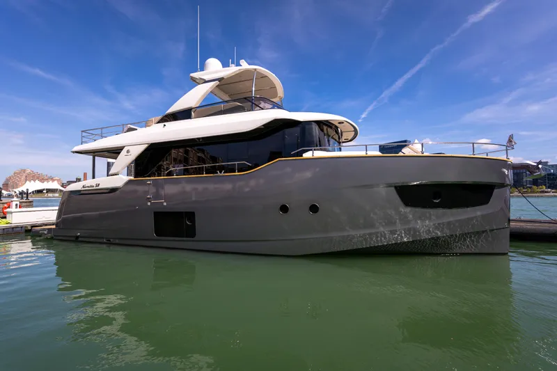 Forever Young Yacht Photos Pics 2018 Absolute 58 Navetta yacht docked in marina under clear blue sky.