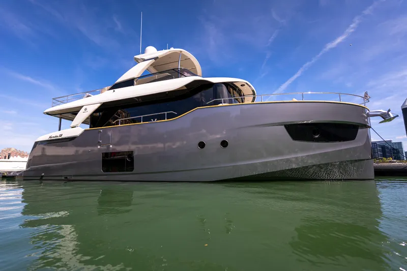 Forever Young Yacht Photos Pics Luxury Absolute 58 Navetta yacht, 2018 model, docked on calm water under clear blue sky.
