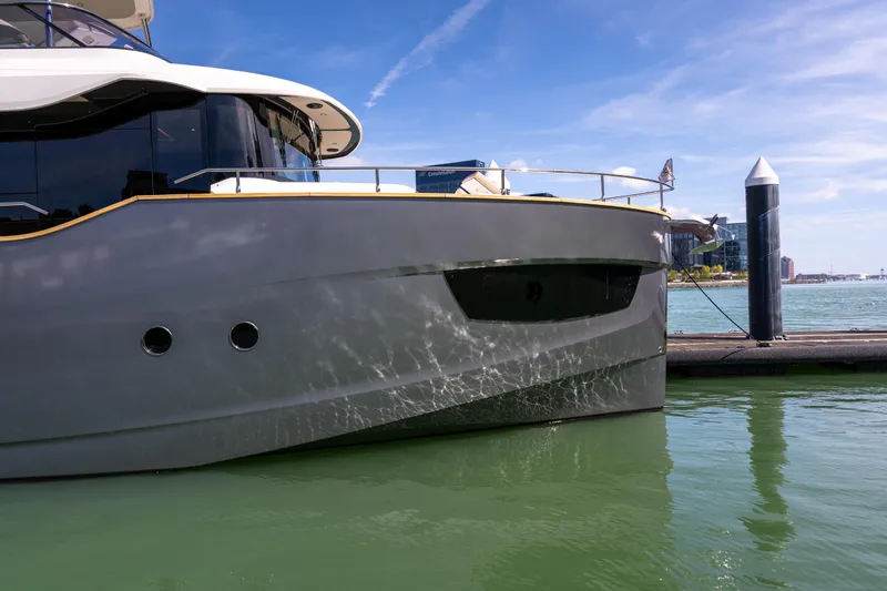 Forever Young Yacht Photos Pics 2018 Absolute 58 Navetta yacht docked in a marina under clear blue skies.