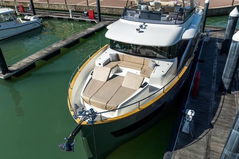 Forever Young Yacht Photos Pics Luxurious 2018 Absolute 58 Navetta yacht docked, featuring spacious sunbathing area and elegant design.