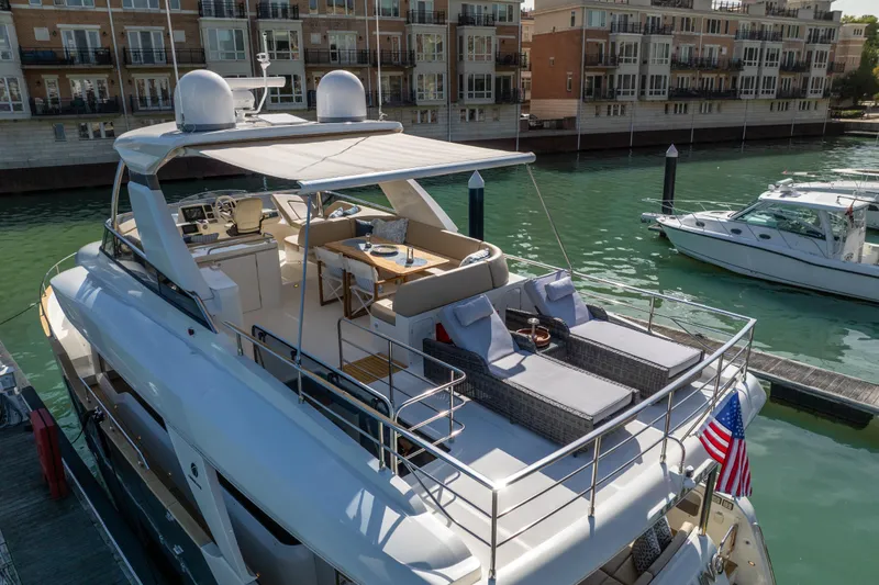 Forever Young Yacht Photos Pics Luxurious 2018 Absolute 58 Navetta yacht docked, featuring spacious deck and elegant seating area.