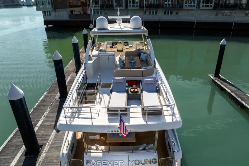 Forever Young Yacht Photos Pics Luxurious 2018 Absolute 58 Navetta yacht docked, featuring spacious deck and elegant design.