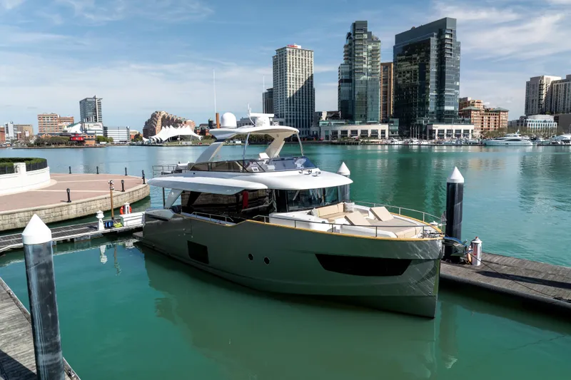 Forever Young Yacht Photos Pics Luxury Absolute 58 Navetta yacht docked in urban marina, city skyline in background, 2018 model.