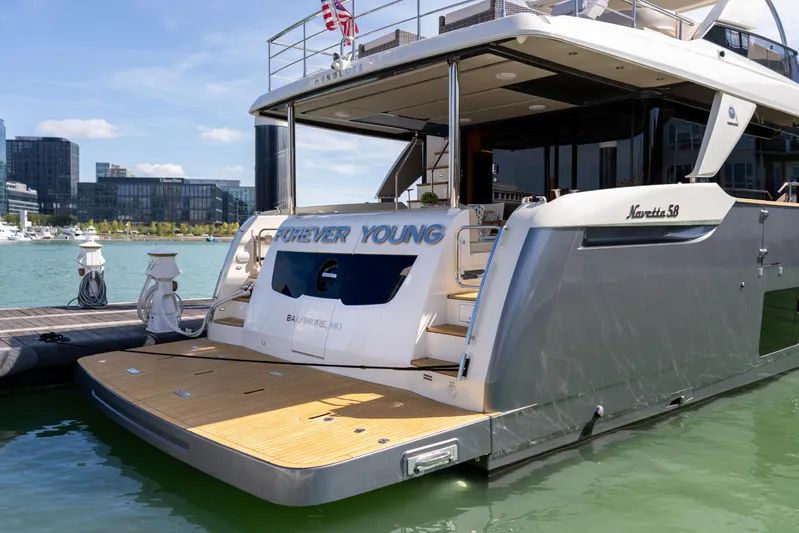 Forever Young Yacht Photos Pics Luxury 2018 Absolute 58 Navetta yacht docked in a marina, rear view.