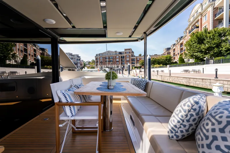 Forever Young Yacht Photos Pics Luxurious 2018 Absolute 58 Navetta yacht with elegant outdoor seating and scenic marina view.