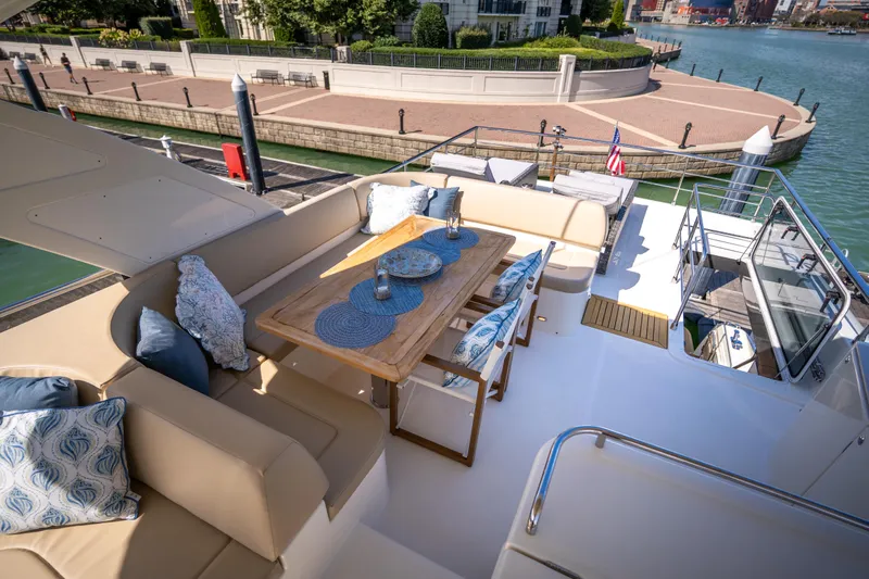 Forever Young Yacht Photos Pics Luxurious 2018 Absolute 58 Navetta yacht deck with elegant seating and dining area.