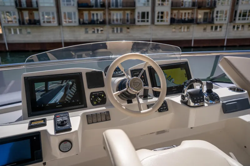 Forever Young Yacht Photos Pics Cockpit of 2018 Absolute 58 Navetta yacht with modern navigation equipment and controls.