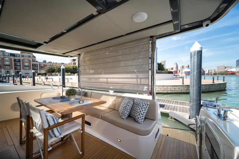 Forever Young Yacht Photos Pics Luxurious 2018 Absolute 58 Navetta yacht with elegant outdoor seating and waterfront view.