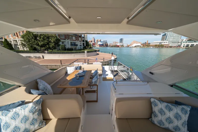 Forever Young Yacht Photos Pics Luxurious 2018 Absolute 58 Navetta yacht with elegant seating and waterfront view.