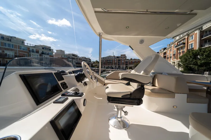 Forever Young Yacht Photos Pics Luxurious helm of 2018 Absolute 58 Navetta yacht with modern controls and seating.