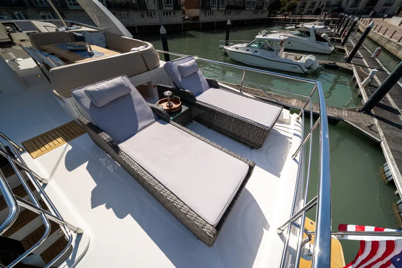 Forever Young Yacht Photos Pics Luxurious 2018 Absolute 58 Navetta yacht with sun loungers and marina view.