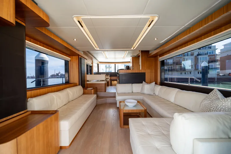 Forever Young Yacht Photos Pics Luxurious interior of 2018 Absolute 58 Navetta yacht with elegant seating and large windows.