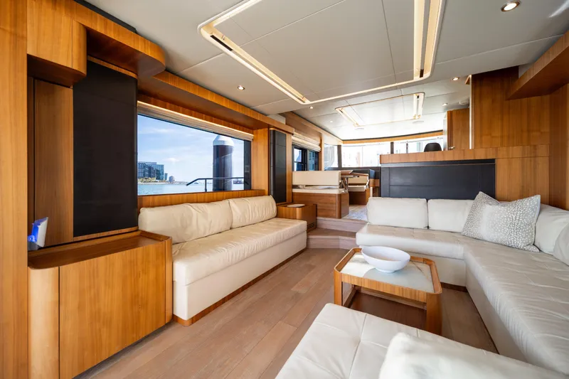 Forever Young Yacht Photos Pics Luxurious interior of 2018 Absolute 58 Navetta yacht with elegant wood and white furnishings.