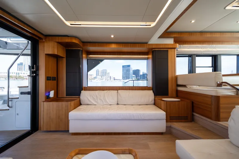Forever Young Yacht Photos Pics Luxurious interior of 2018 Absolute 58 Navetta yacht with modern wood and white furnishings.