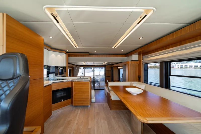 Forever Young Yacht Photos Pics Luxurious interior of 2018 Absolute 58 Navetta yacht with modern wood finishes and spacious seating.