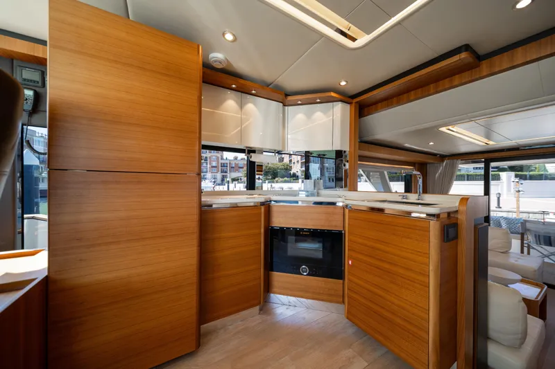 Forever Young Yacht Photos Pics Luxurious kitchen interior of 2018 Absolute 58 Navetta yacht with modern wood finish.