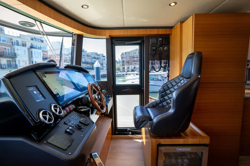 Forever Young Yacht Photos Pics Luxurious helm of 2018 Absolute 58 Navetta yacht with modern controls and leather seating.