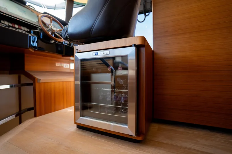 Forever Young Yacht Photos Pics Mini fridge in the helm area of a 2018 Absolute 58 Navetta yacht.