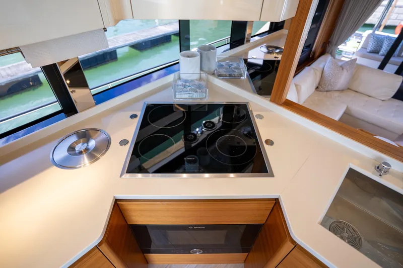Forever Young Yacht Photos Pics Modern kitchen on 2018 Absolute 58 Navetta yacht with sleek cooktop and luxurious interior.