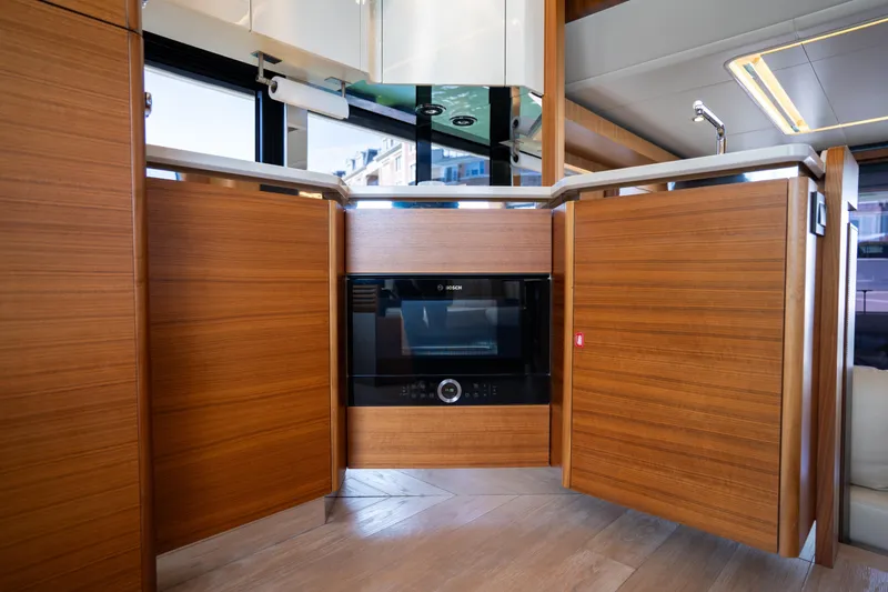 Forever Young Yacht Photos Pics Luxurious kitchen interior of 2018 Absolute 58 Navetta yacht with modern appliances.