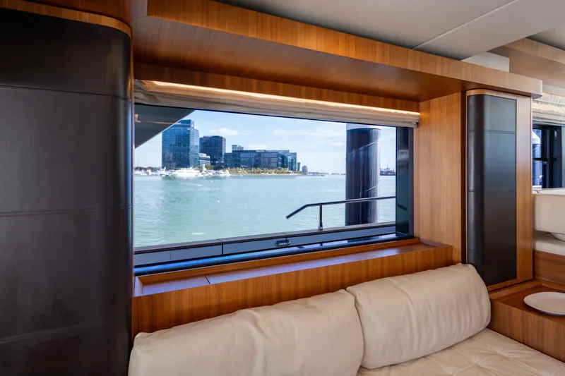 Forever Young Yacht Photos Pics Luxurious interior view from 2018 Absolute 58 Navetta yacht, showcasing waterfront cityscape.