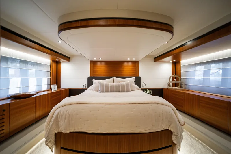 Forever Young Yacht Photos Pics Luxurious bedroom interior of 2018 Absolute 58 Navetta yacht with elegant wood finishes.