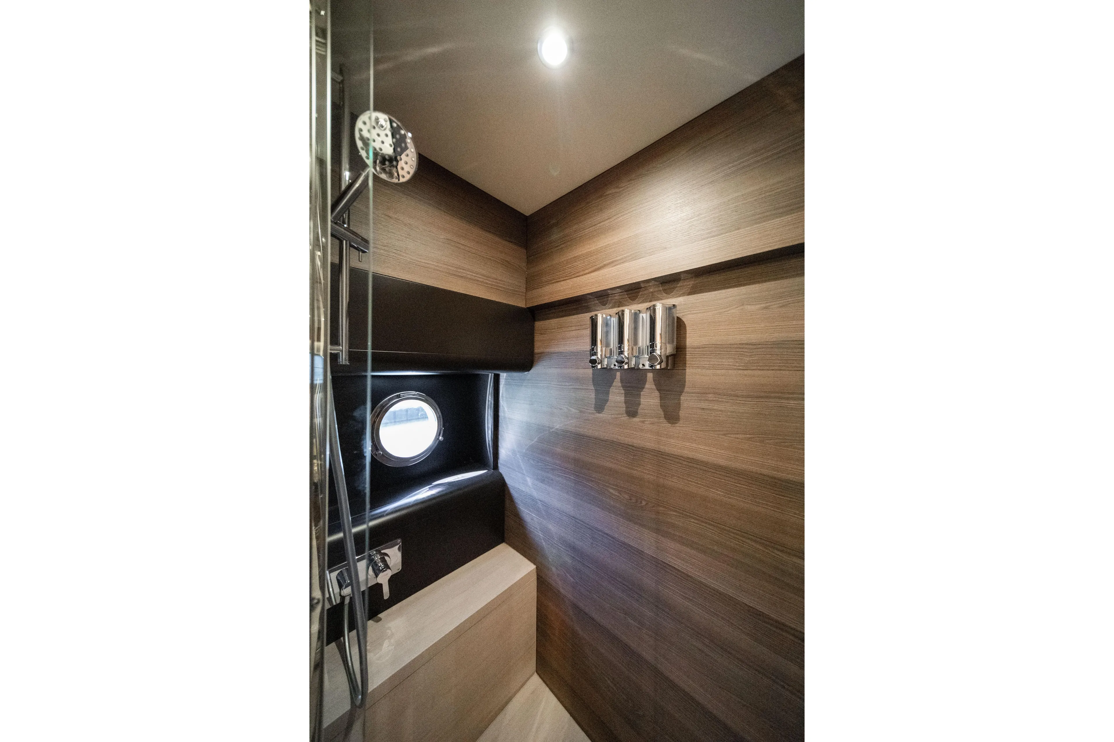 Forever Young Yacht Photos Pics Luxurious bathroom interior of 2018 Absolute 58 Navetta yacht with modern wood paneling.