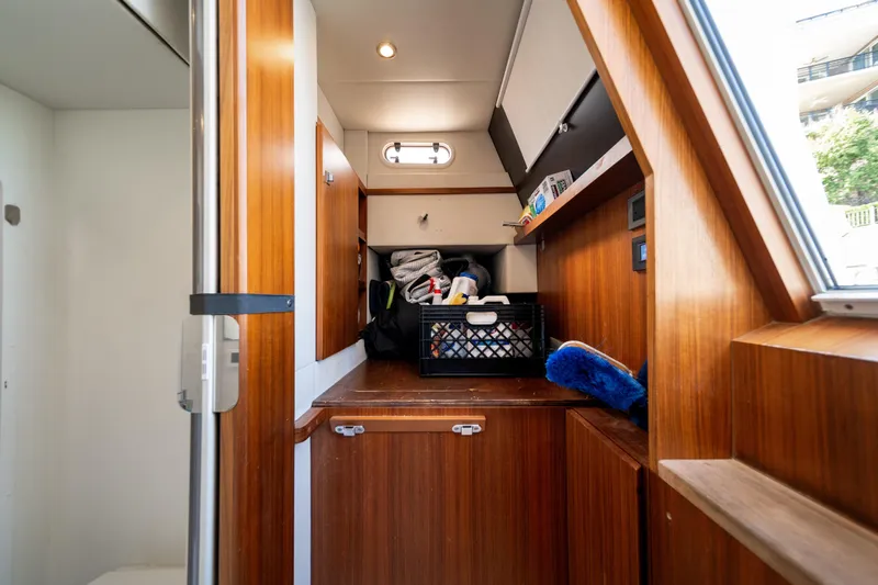 Forever Young Yacht Photos Pics Interior of 2018 Absolute 58 Navetta yacht with wooden cabinetry and storage area.