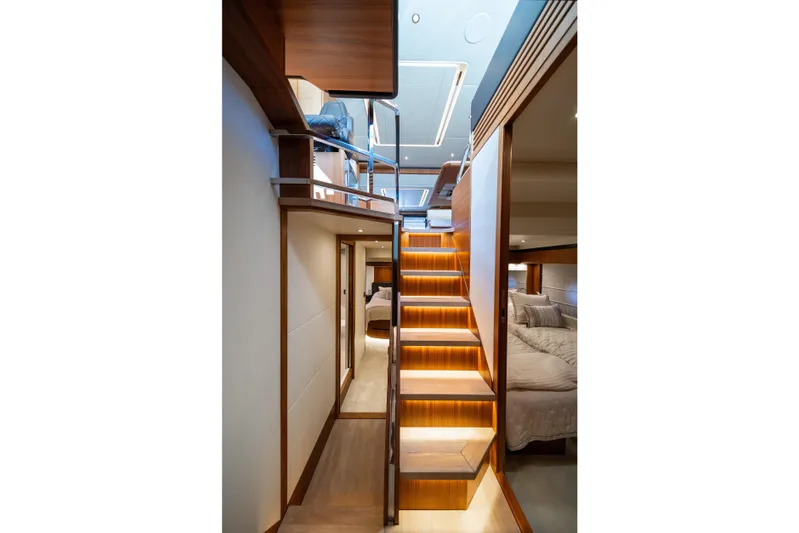 Forever Young Yacht Photos Pics Luxurious interior of 2018 Absolute 58 Navetta yacht with illuminated wooden staircase.
