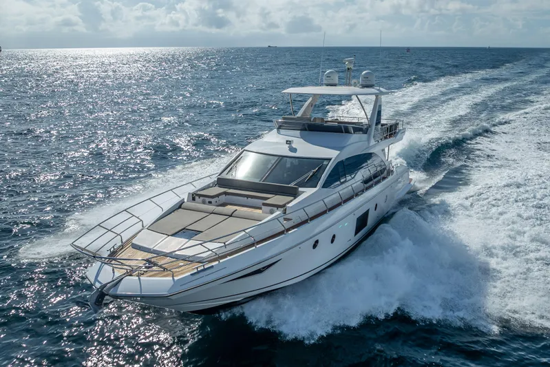  Yacht Photos Pics Luxurious 2019 Azimut 66 yacht cruising on open sea under clear skies.