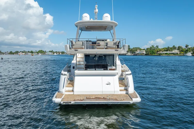  Yacht Photos Pics 2019 Azimut 66 yacht on calm water, showcasing luxurious rear deck and seating.